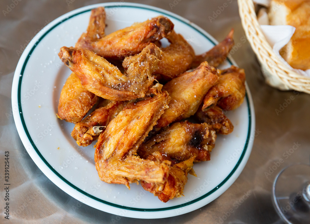 Picture of dish of tasty fried chicken wings served at plate