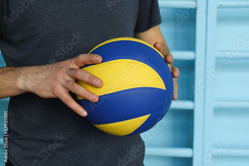 Volleyball competition, the player holds the ball before the start of the game, team sport in the gym, copy space