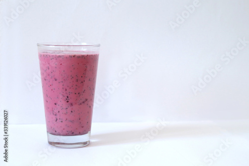 Wallpaper Mural Pink strawberry smoothie in glass on a white background, sports drink after training, protein, bifidobacteria, copy space Torontodigital.ca