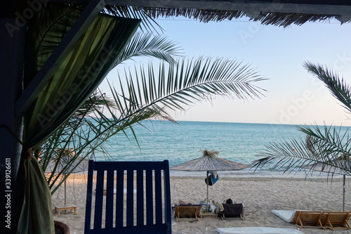 Beach view with straw umbrellas.