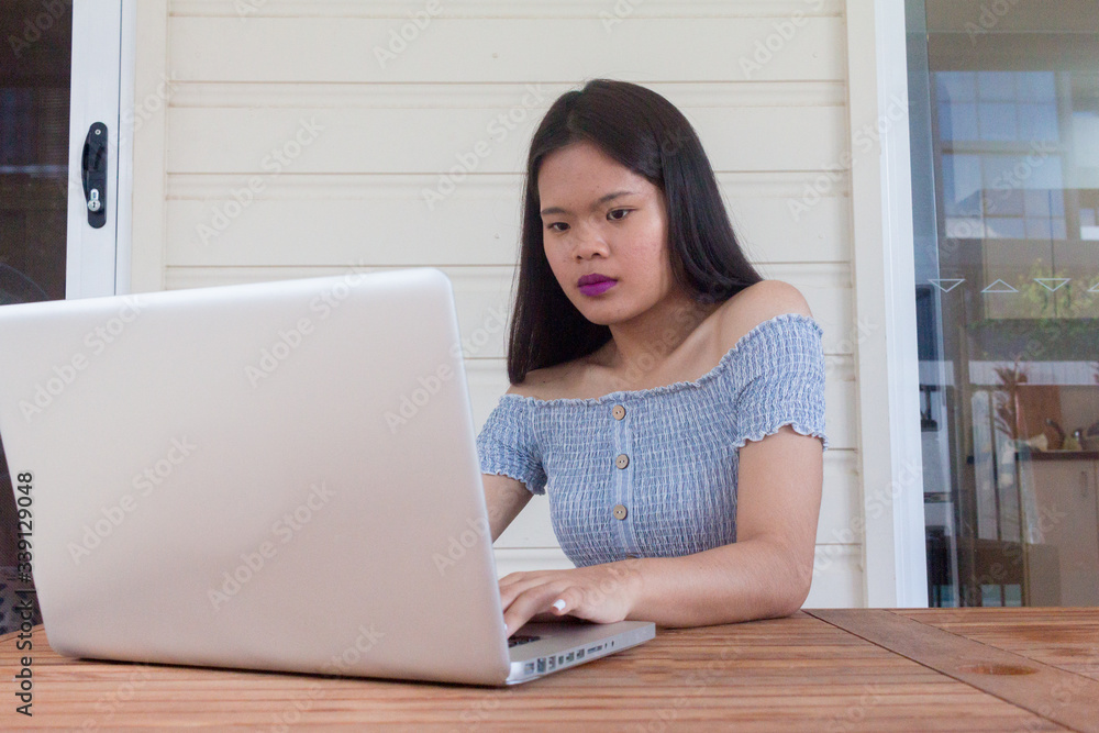 Asian girl working on laptop from home office Asian girl working on laptop from home office