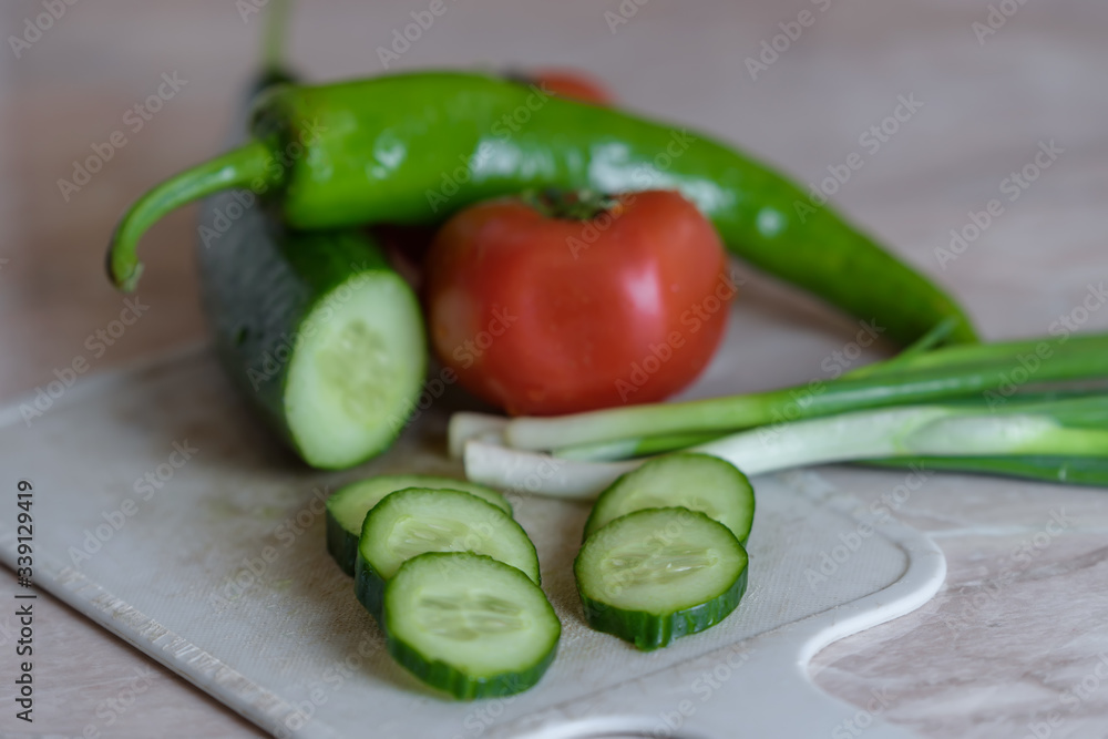 sliced cucumber against the background of vegetables sliced cucumber against the background of vegetables
