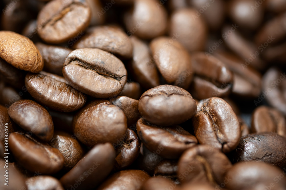 Fototapeta premium Top view of brown roasted coffee beans, can be use as background, copy space for text.