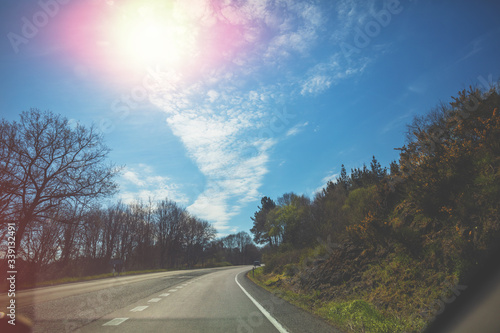 Driving a car on a highway on a spring sunny day