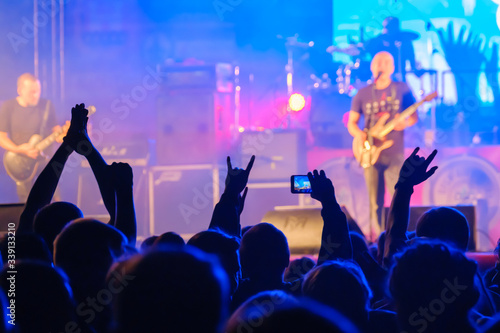 Fans listening to rock band on stage