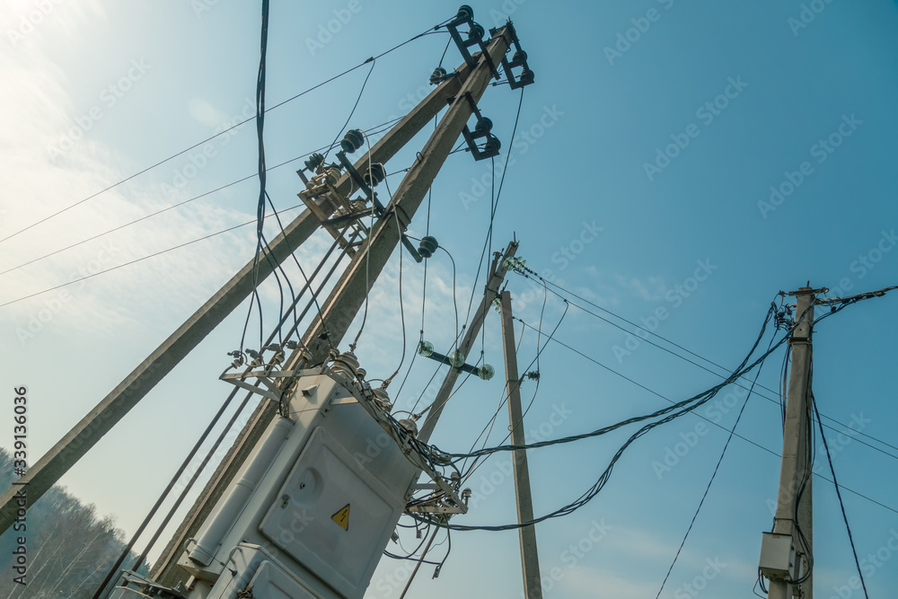 Power system with an electric panel with a warning sign Danger against a blue sky close up Power system with an electric panel with a warning sign Danger against a blue sky close up