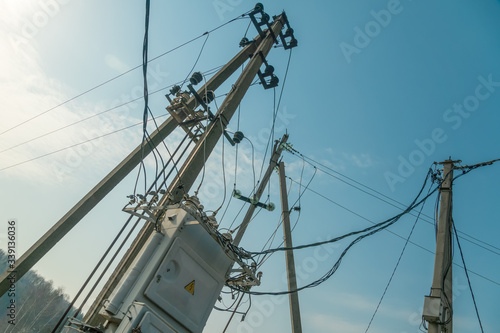 Power system with an electric panel with a warning sign Danger against a blue sky close up