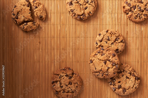  Chocolate chip cookies on a wooden background.
