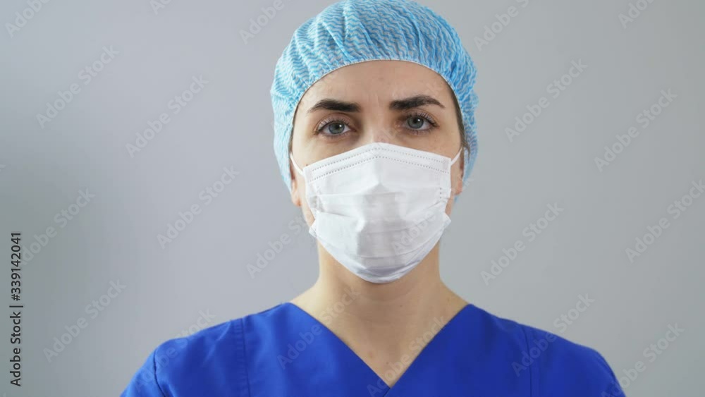 health, medicine and pandemic concept - female doctor or nurse wearing protective face mask with drug or vaccine in syringe health, medicine and pandemic concept - female doctor or nurse wearing protective face mask with drug or vaccine in syringe