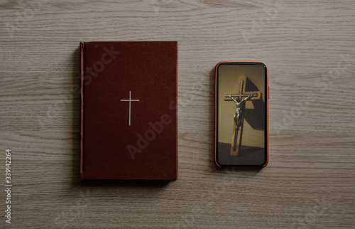 Worship from home, Online live church for good friday service, Top view of mobile screen with wooden cross photo and bible with