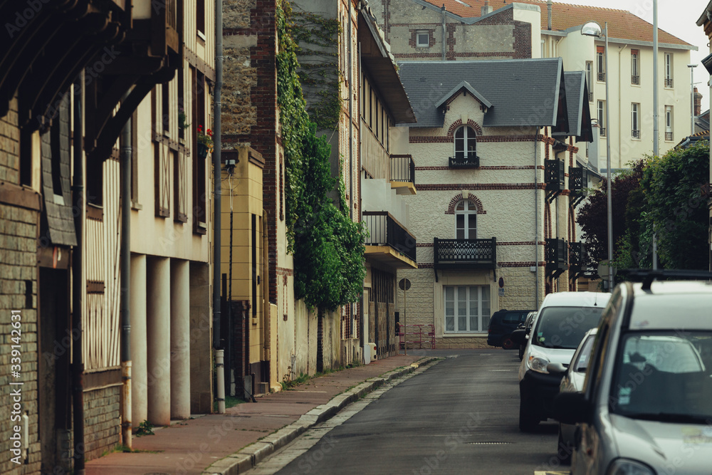Typical Normandy architecture and deserted streets with no tourists while citizens stay at home in self isolation. Residential buildings facades, expensive real estate concept, economic crisis