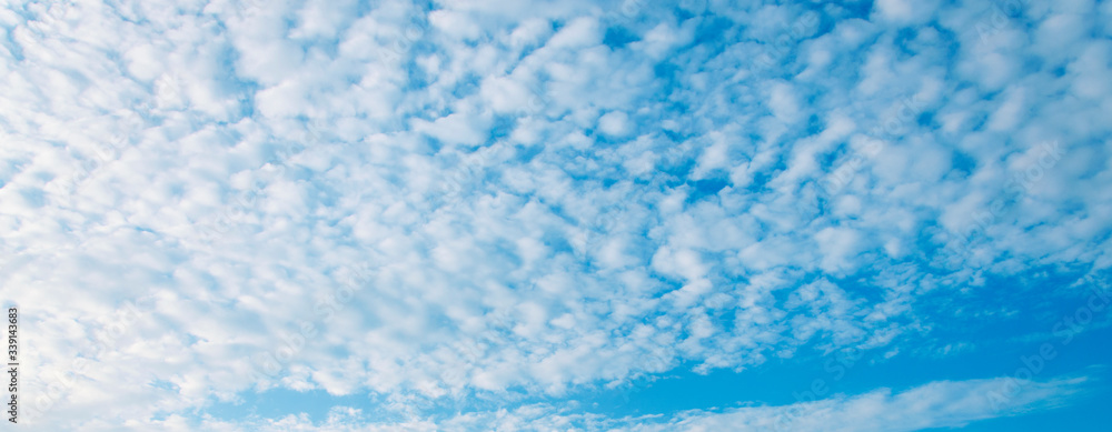 Beautiful airy white clouds on a background of blue sky, Background banner