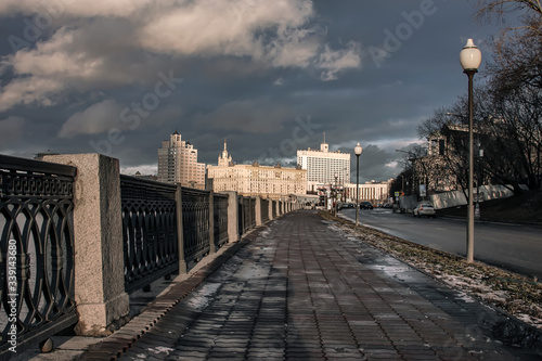 Embankment with a fence and buildings in the distance © Kooper