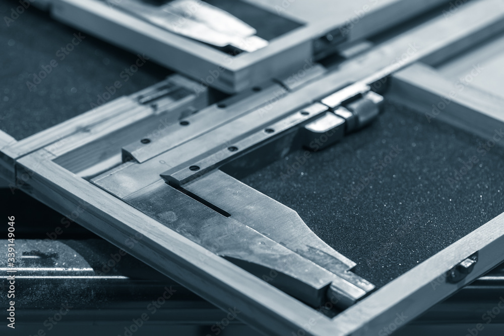 Steel calipers in cases are on a table, blue toned Steel calipers in cases are on a table, blue toned