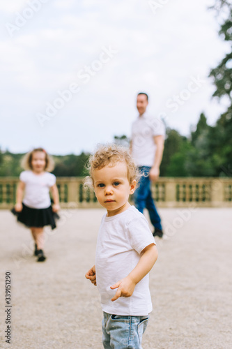 Handsome young father and beautiful mother in sunny summer nature playing with their cute small childrens © jul14ka