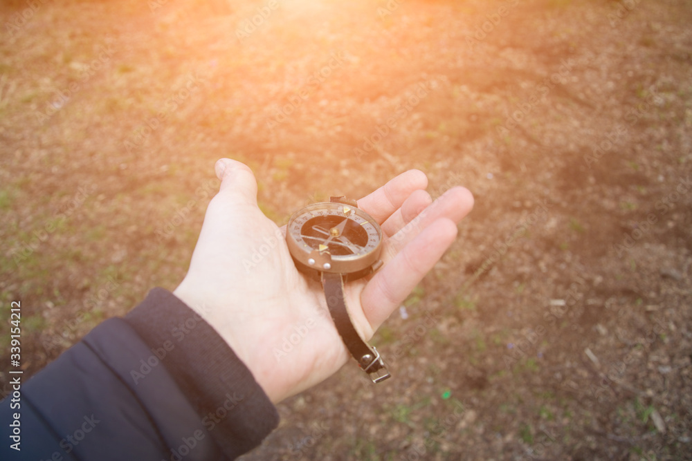 photo of man's hand with vintage compass