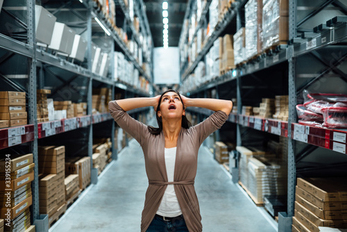 Woman looking lost,in shock.Buying in hardware store.Arts and crafts shopping.Hoby store.Home renovation.Interior designer.Handmade creative do it yourself project supplies.Refurbishing.Makeover idea. photo