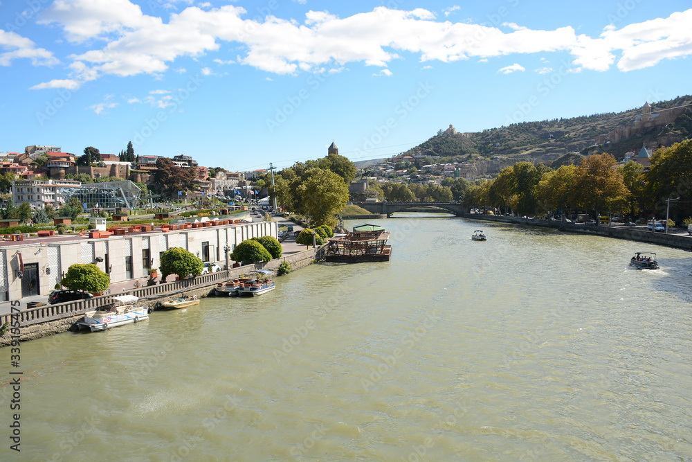 Tbilisi, Georgia - October 4, 2018: View to Mtkvari river from Bridge Of Peace