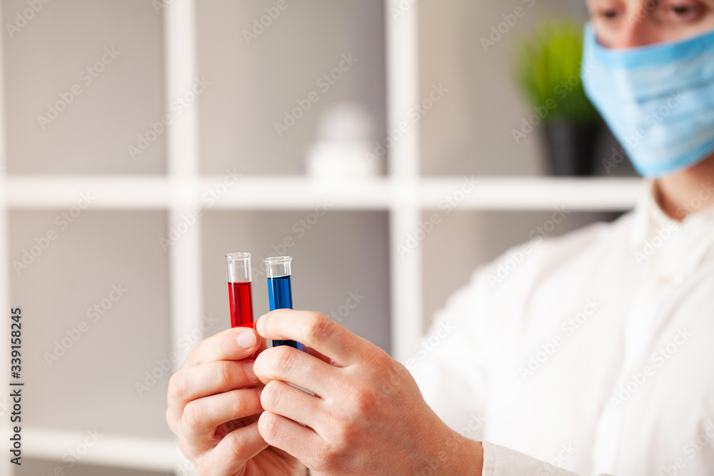 Doctor holds test tube with covid-19 test. Doctor holds test tube with covid-19 test.