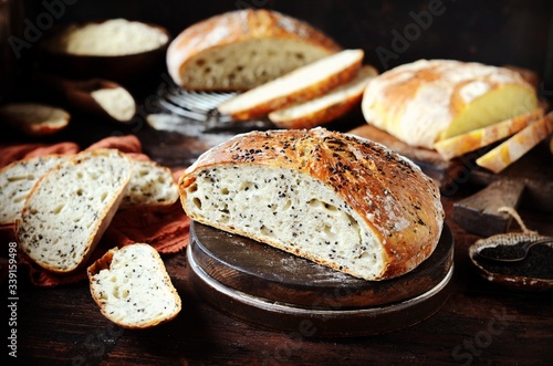 Homemade bread assortment: corn, with sesame seeds and chia seeds on a dark wooden background. rustic