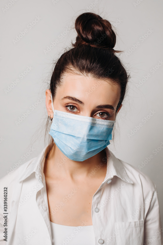 Portrait young European woman wearing hygienic mask to prevent infection isolated on white background. Portrait young European woman wearing hygienic mask to prevent infection isolated on white background.