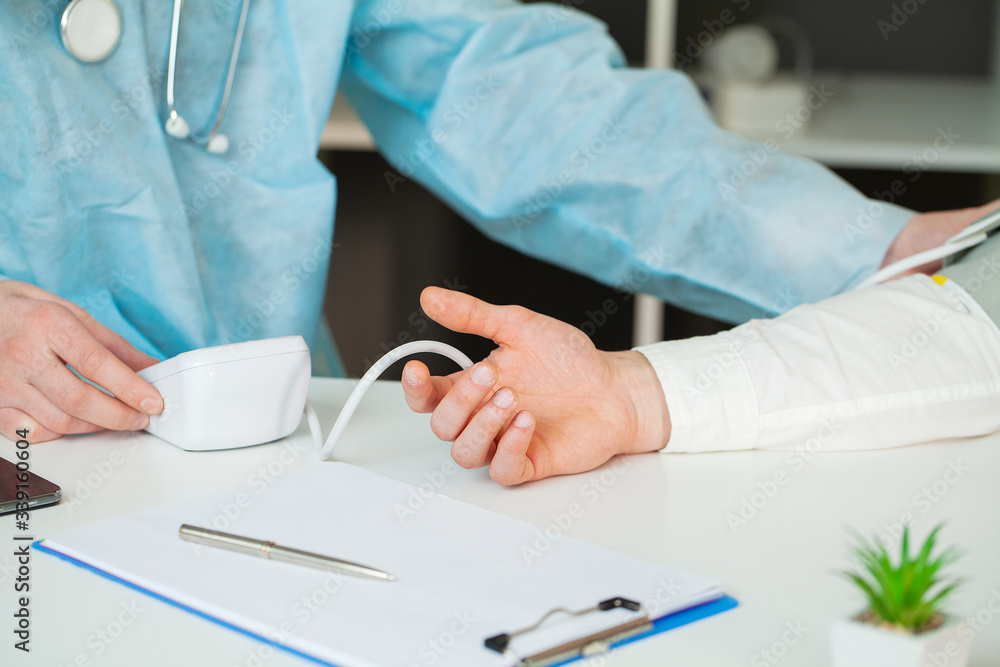Doctor measures the pressure of the patient in clinic. Doctor measures the pressure of the patient in clinic.