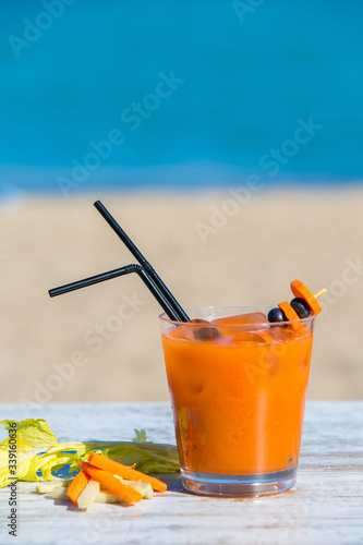 Carrot juice with the sea in the background