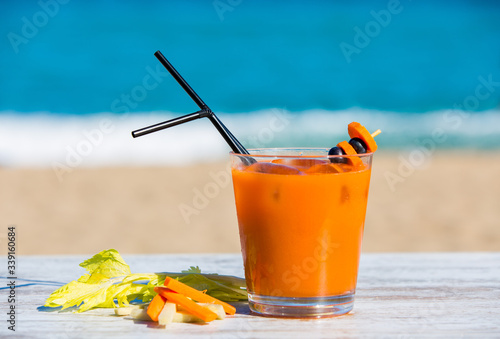 Carrot juice with the sea in the background