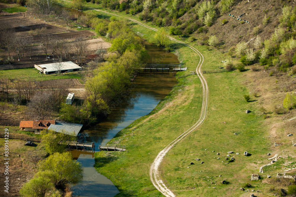 Beautiful spring landscape in Republic of Moldova. Green landscape. Spring Nature. Park with Green Grass and Trees. Travel in Europe. Field with blooming tree and rocks. Beautiful spring landscape in Republic of Moldova. Green landscape. Spring Nature. Park with Green Grass and Trees. Travel in Europe. Field with blooming tree and rocks.