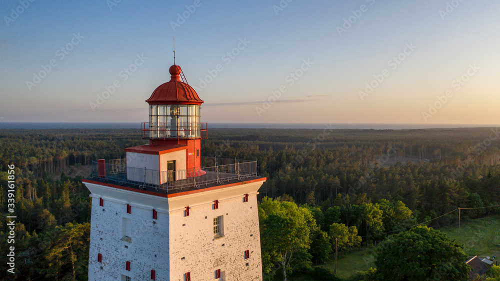 Aerial sunset colored  view to the medieval Kõpu lighthouse in Hiiumaa island, Estonia. It is one of the oldest functioning lighthouses in Northern Europe