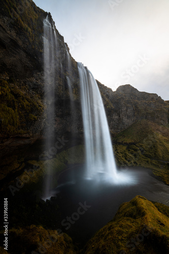 Iconic scenic Seljalandsfoss on a cloudy day in autumn in Iceland