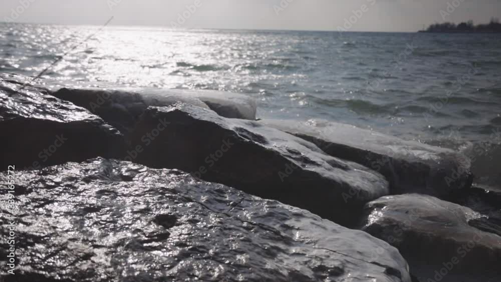 The icy rocks by the shore of Canada during winter - slow motion The icy rocks by the shore of Canada during winter - slow motion