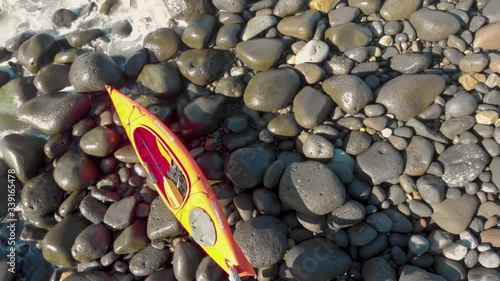 A kayaker preparing his kayak before entering the ocean.