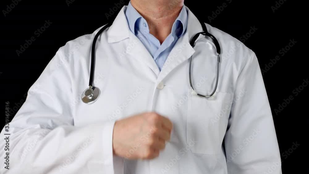 Male doctor hand showing thumbs up on medical gown and stethoscope background. Close up doctor showing thumbs up front camera in black studio Male doctor hand showing thumbs up on medical gown and stethoscope background. Close up doctor showing thumbs up front camera in black studio