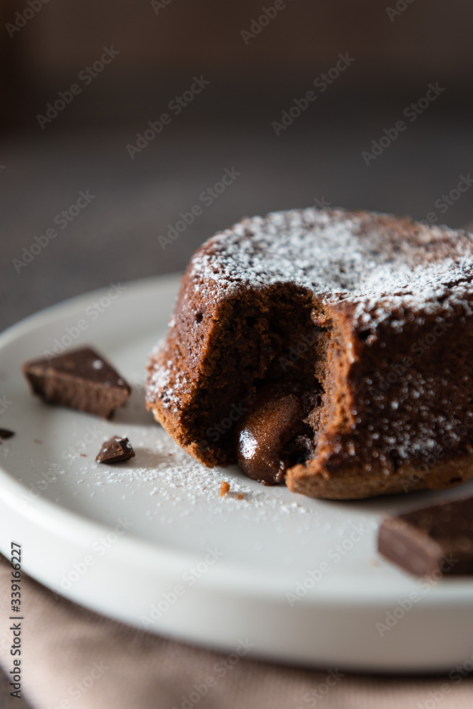 Delicious fresh fondant with hot chocolate centre on the plate. Lava cake recipe, menu. Close up Delicious fresh fondant with hot chocolate centre on the plate. Lava cake recipe, menu. Close up