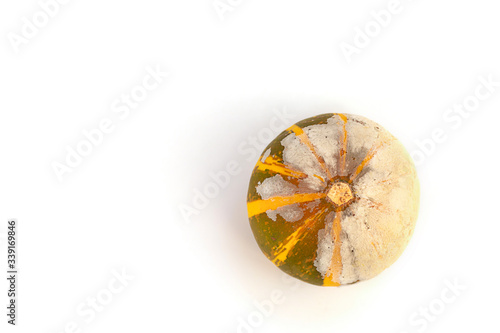 Moldy pumpkin on a white background with copy space. Ugly food. Flat lay. Top view