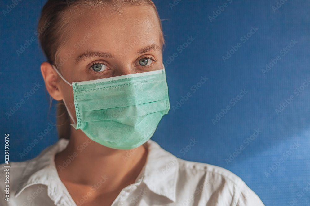girl in a medical mask on a dark blue background girl in a medical mask on a dark blue background
