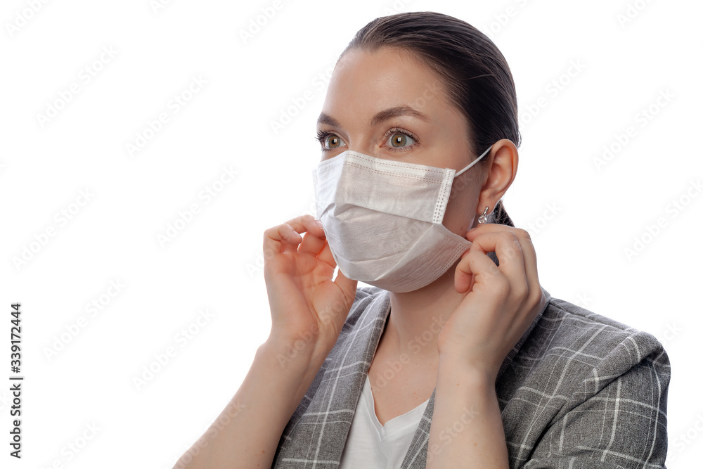 young woman on a white background in a medical mask young woman on a white background in a medical mask