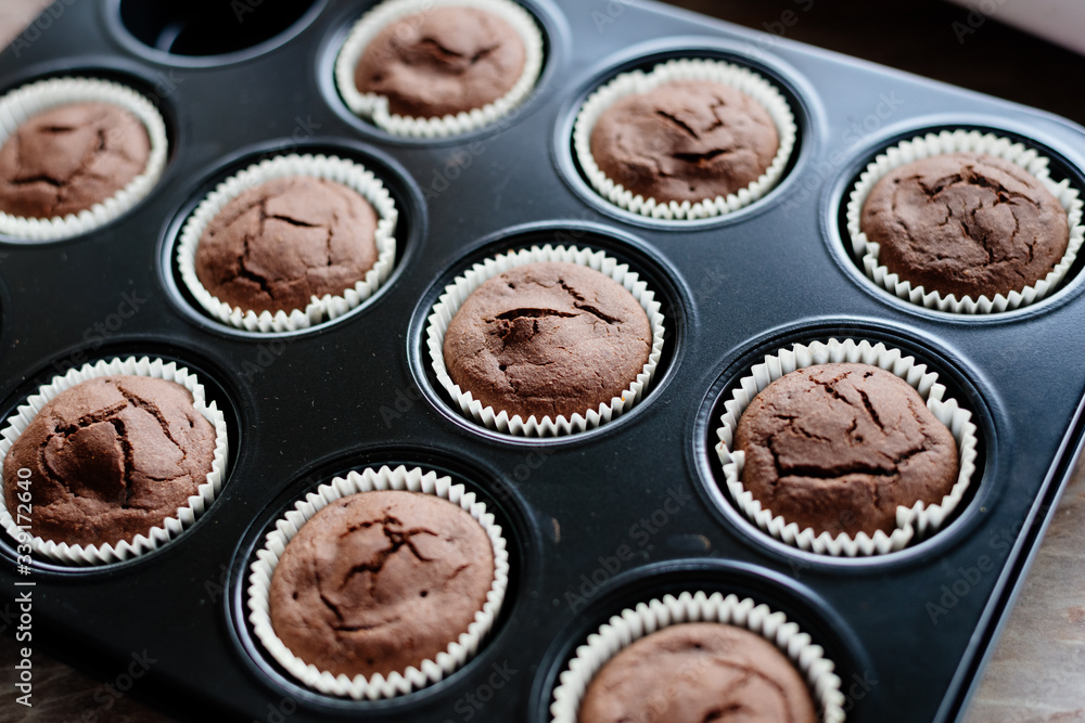 Chocolate cupcakes. Homemade chocolate muffins. The process of making homemade chocolate cupcakes with whipped cream and decorated with chocolate and raspberry pieces. Chocolate cupcakes. Homemade chocolate muffins. The process of making homemade chocolate cupcakes with whipped cream and decorated with chocolate and raspberry pieces.