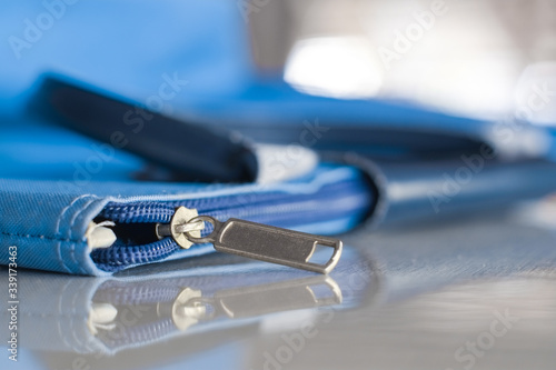 Zipper or slide fastener of fabric bag close-up.