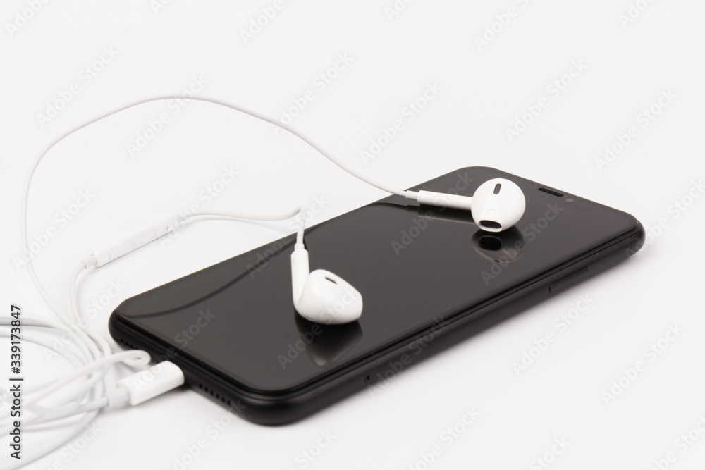 Creative flat lay photo of workspace desk with earphones and mobile phone Creative flat lay photo of workspace desk with earphones and mobile phone