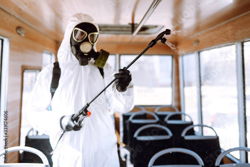 Cleaning and Disinfection public transport.Man in protective suit washing and disinfection public transport, to preventing the spread of the epidemic of coronavirus, pandemic in quarantine city. 