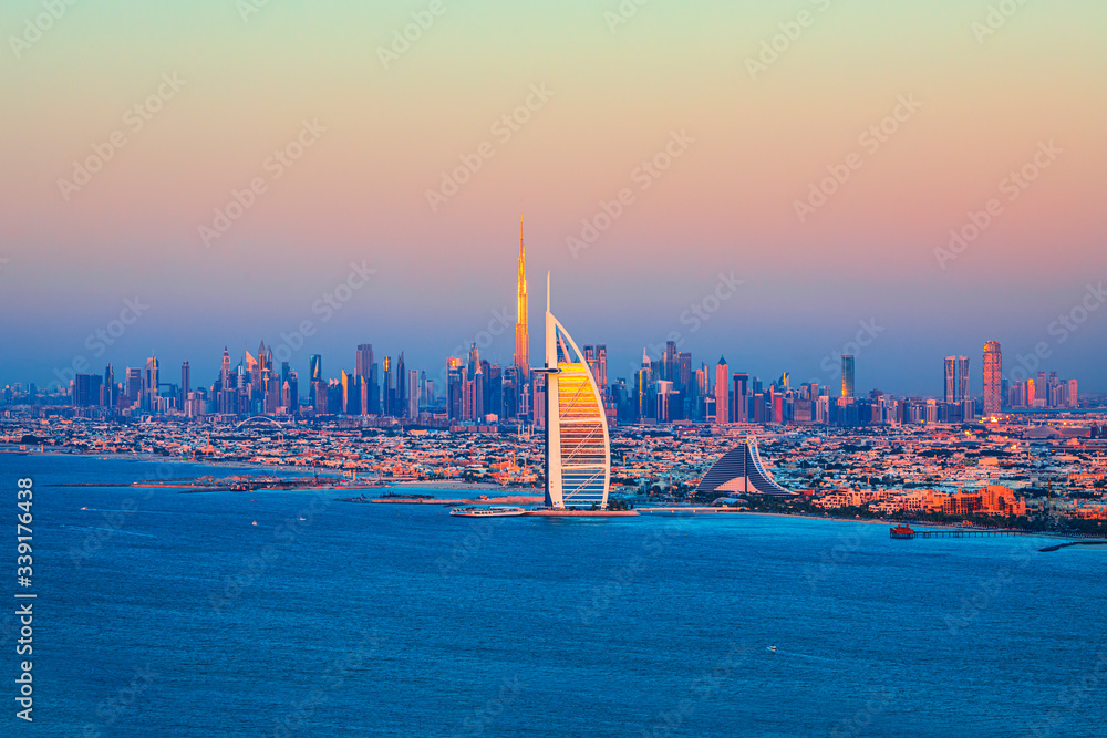 Fototapeta premium Dubai Marina, city of tourism from Palm Island at sunrise, United Arab Emirates