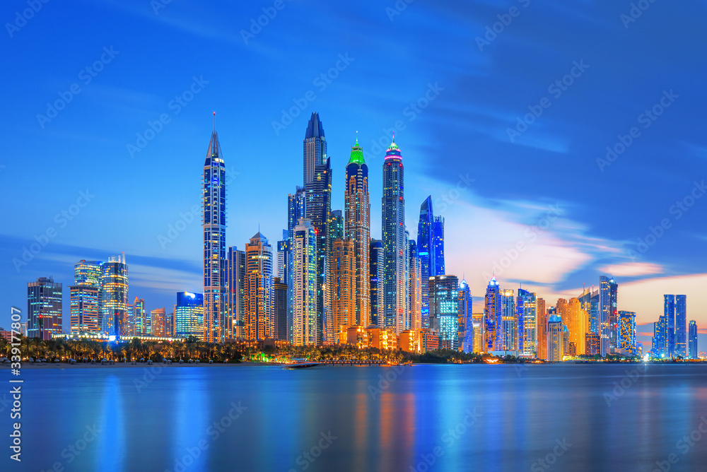 Obraz premium Dubai Marina, city of tourism from Palm Island at sunrise, United Arab Emirates