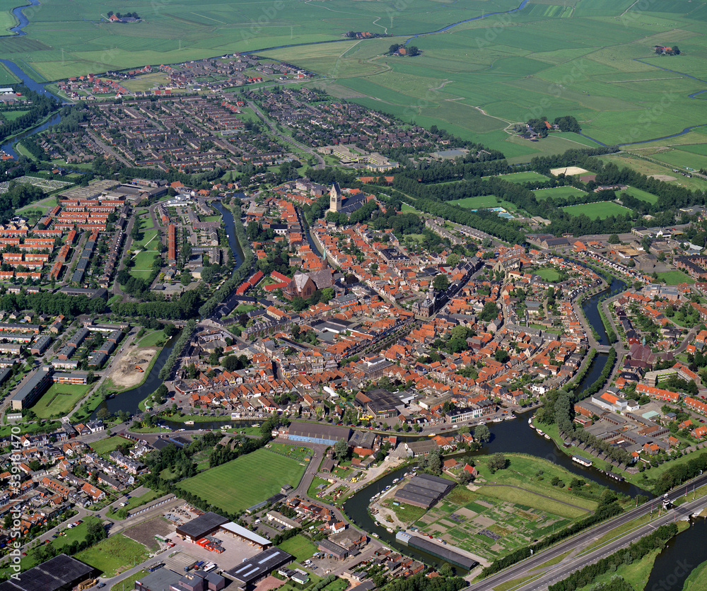 Obraz premium Bolsward, Holland, July 12 - 1990: Historical aerial photo of the city Bolsward in the Dutch province Friesland
