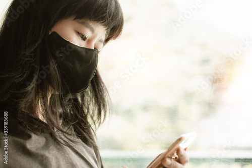 Asian woman wearing a black...