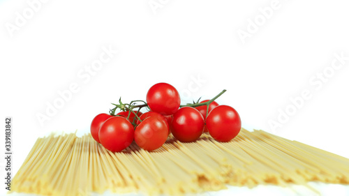 spaghetti and cherry tomatoes: typical ingredients of Italian cuisine in a minimalist composition with a totally white background