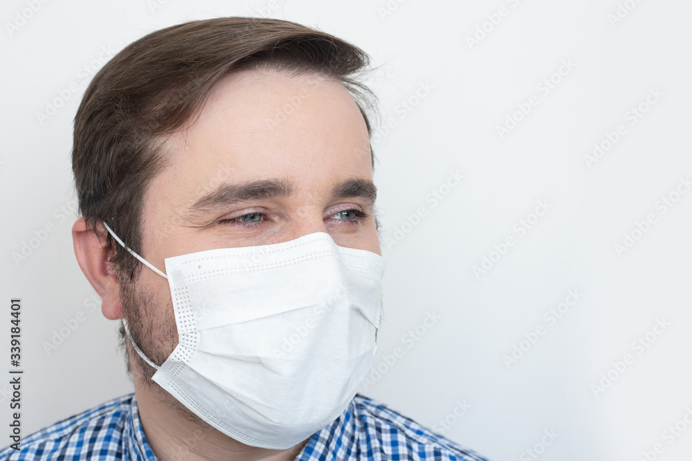 Man wearing protective mask on white background, copyspace, copyplace, space for text. Coronavirus, illness, infection, quarantine, medical mask