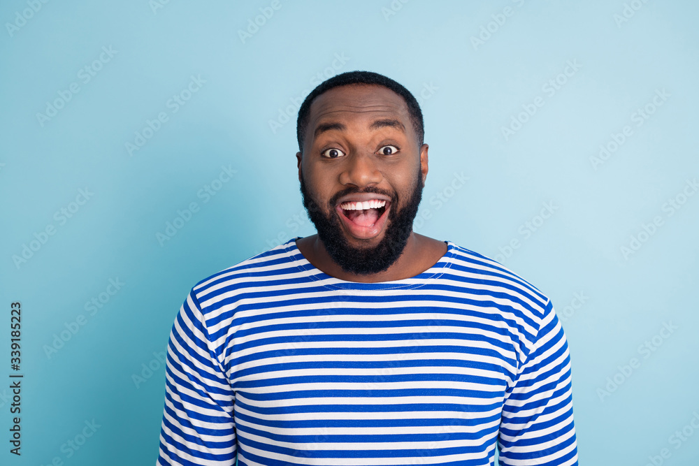 Astonished funky afro american guy look see incredible black friday summer time season bargains impressed scream unbelievable unexpected wear nautical frock isolated blue color background Astonished funky afro american guy look see incredible black friday summer time season bargains impressed scream unbelievable unexpected wear nautical frock isolated blue color background