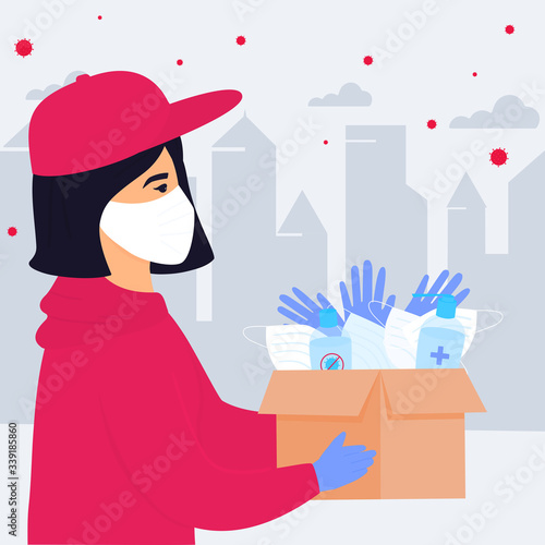 COVID-19. Coronavirus epidemic. Volunteer girl delivering parcel with medical protective masks, gloves and disinfectants.